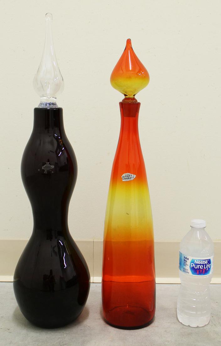 (2) BLENKO GLASS VASES: Blenko glass vases, amberina and red with clear stopper. 21" to 23" tall.