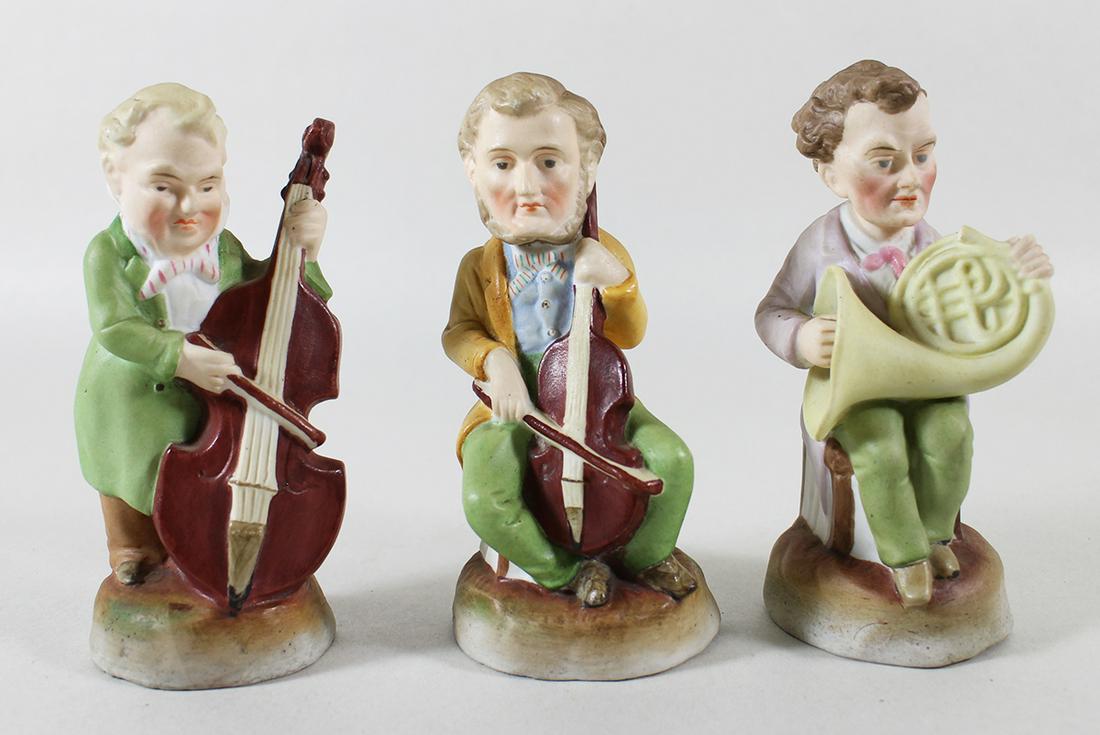 (3) 19th C GERMAN BISQUE MUSICIAN FIGURINES: A set of 3 bisque painted musicians. One is playing the cello, one the French horn and one a bass violin. They are about 5" tall.