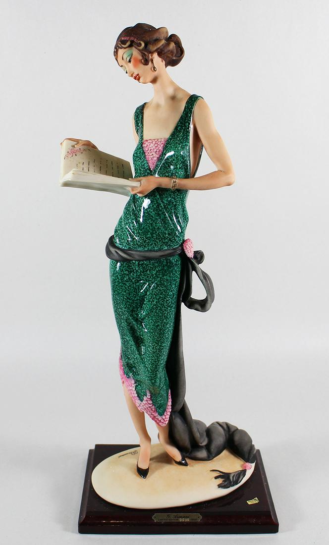GIUSEPPE ARMANI #384C "LADY HOLDING A BOOK": Giuseppe Armani figurine of a lady reading a book. It is a Limited Edition numbered 36 / 5000. It stands 18" tall.