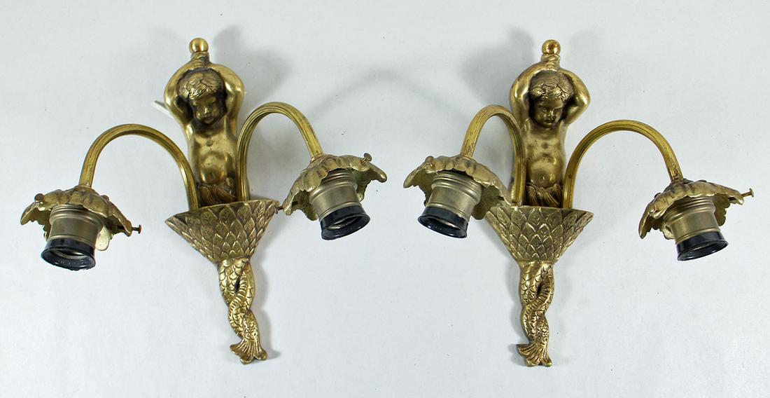 (2) CHERUB SCONCES: Pair of metal cherub wall sconces. 11" long 12" wide without shades.