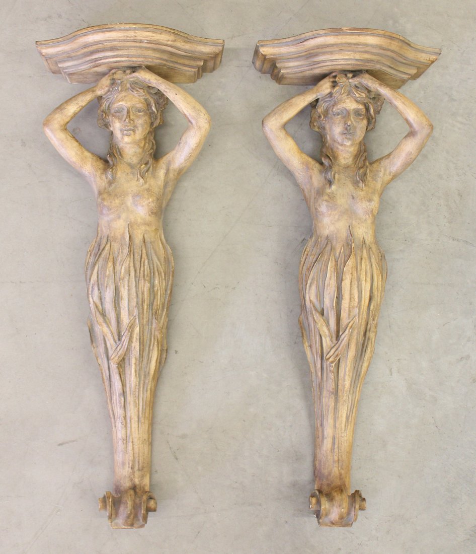 (2) FEMALE WALL SCONCE SHELVES: Pair of figural semi nude female wall corbel shelves. Each weighs approximately 20 lbs. 31.5" long, 12.25" wide at top.