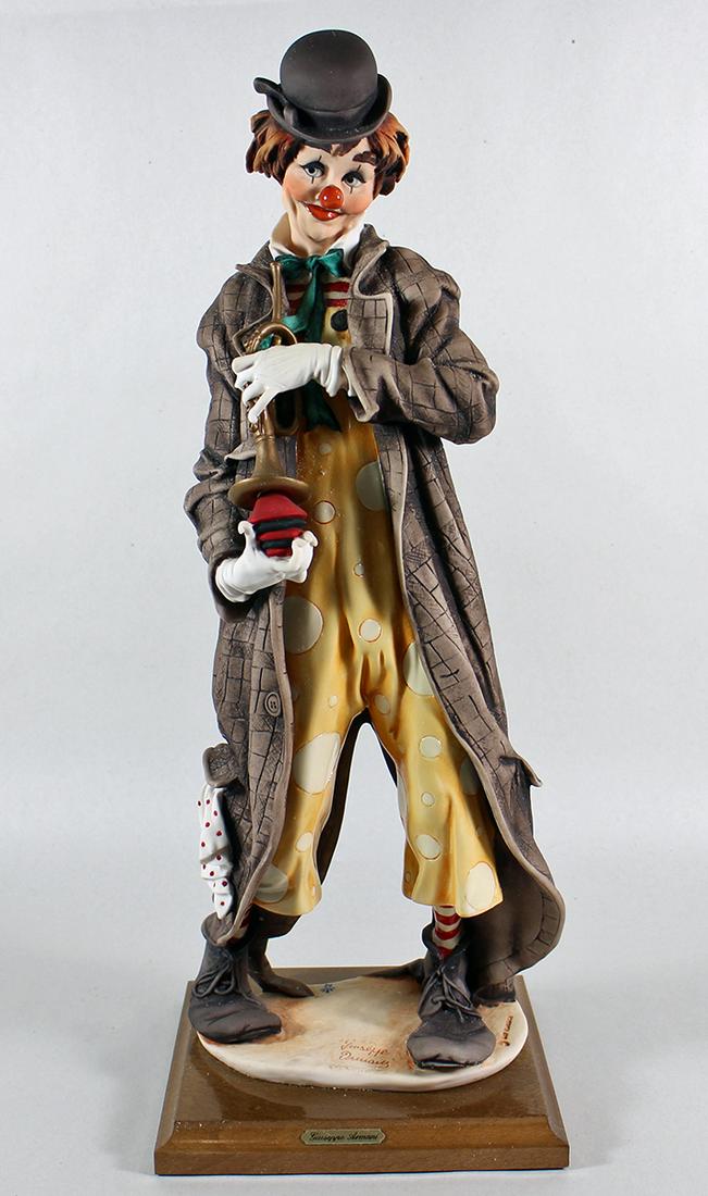 GIUSEPPE ARMNI CLOWN FIGURINE: Giuseppe Armani figurine of a musical clown with trumpet. Measures 18" tall and comes with original box. # 401E 401 E.