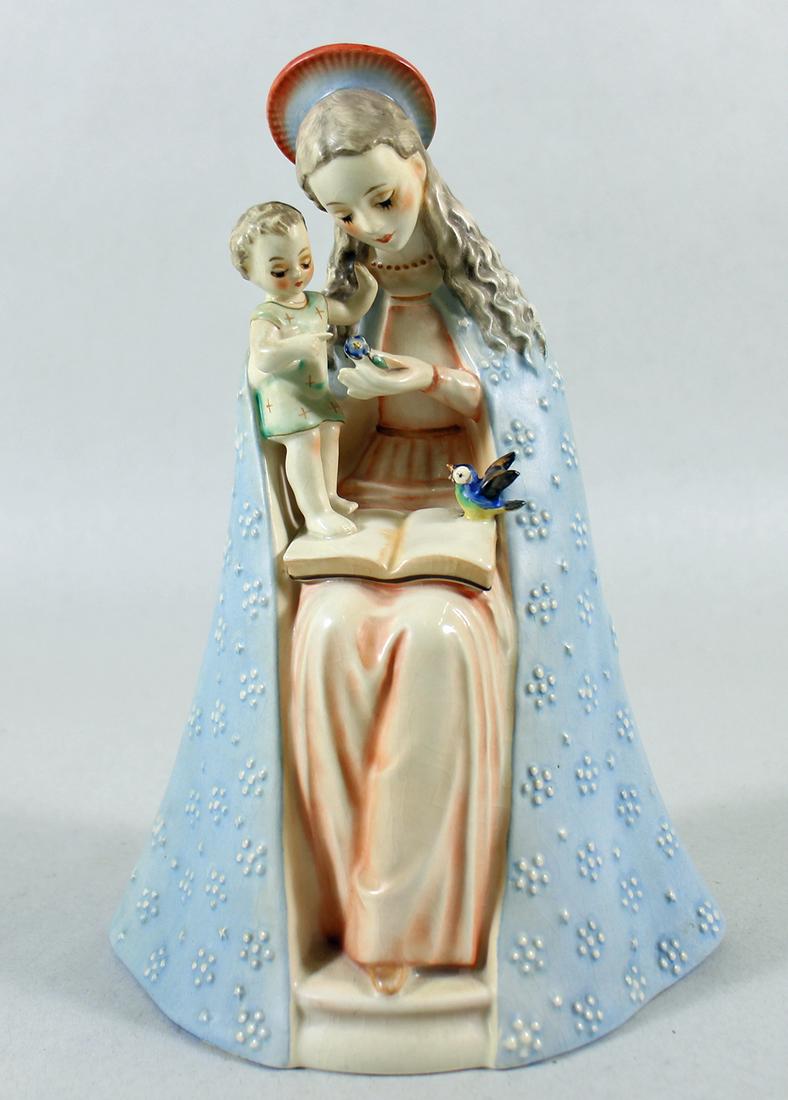 HUMMEL MADONNA & CHILD FIGURINE: A vintage Hummel Madonna figurine holding the baby Jesus while holding a book and bluebird. Repair to baby head. TMK3 Measures 8" tall.