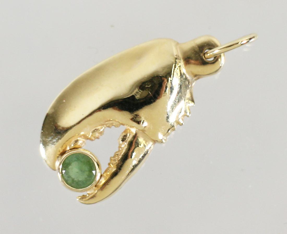 LINDA BEAN 14K MAINE LOBSTER CLAW PENDANT: Linda Bean (granddaughter of Leon Leonwood Bean - LL Bean) 14KT yellow gold Maine lobster claw pendant with green stone. Marked LLBM (Linda Bean's Perfect Maine) 14K. 1" long, 5.5" DWT.