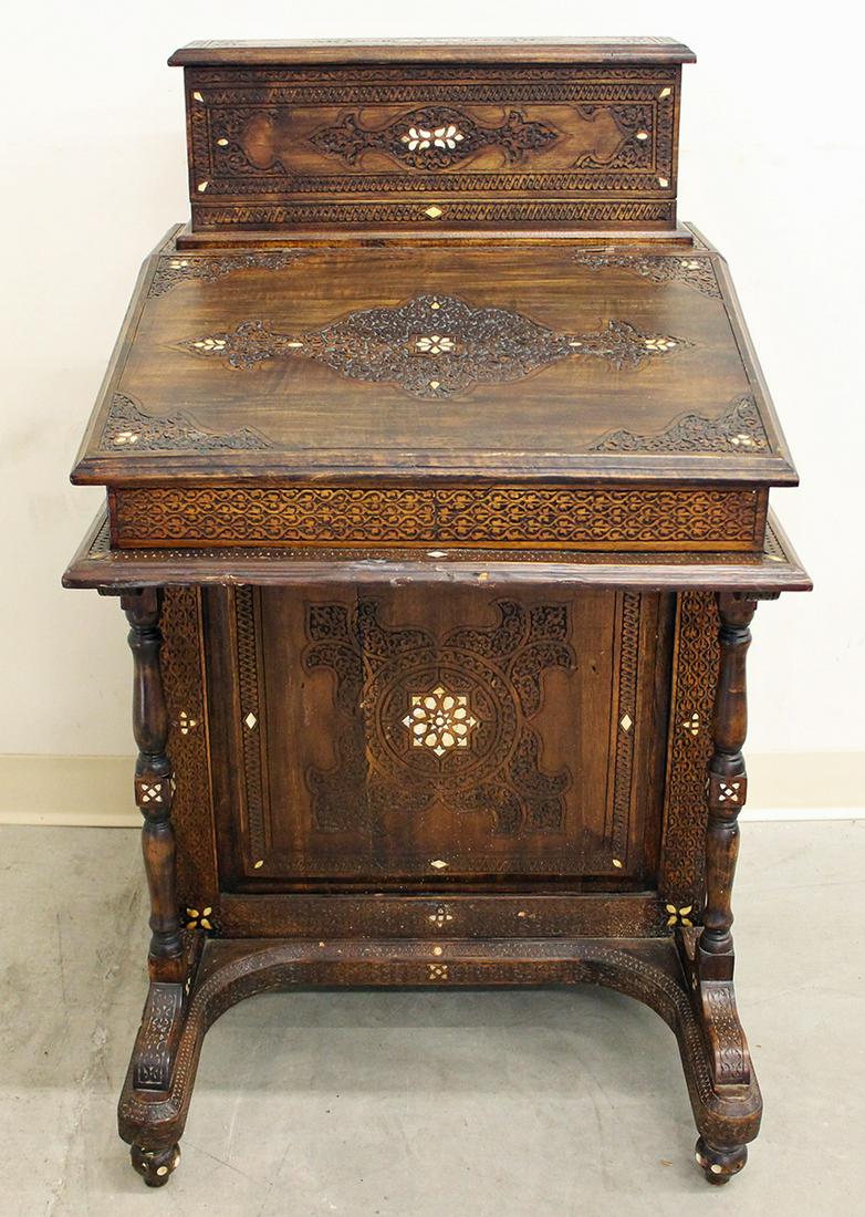 ANGLO INDIAN INLAID DAVENPORT DESK: Anglo Indian carved wood davenport desk. Door on side locked (no key). There are signs of wood beetle damage in several areas. Measures 24.5" x 24.5" wide 42" tall.