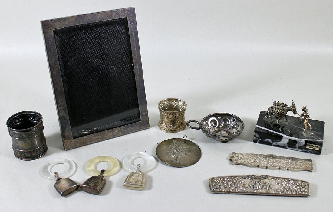 STERLING SILVER COLLECTION: Includes napkin rings, baby rattles, wine salver, a 1971 Towle partridge in a pear tree ornament, combs, a sculpture and a Wallace sterling frame.