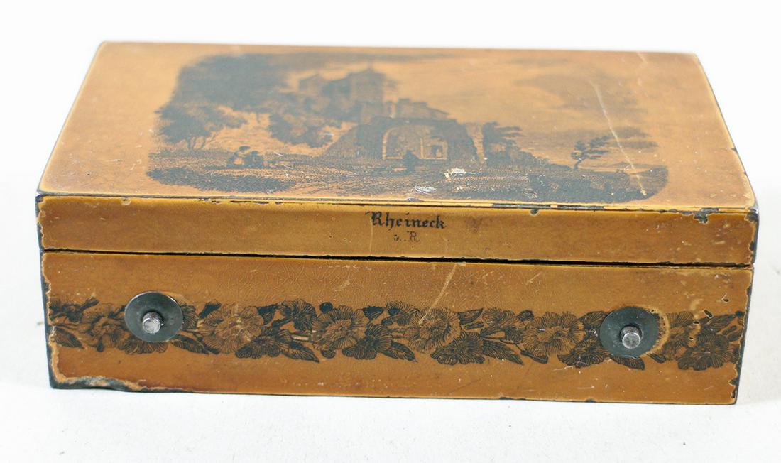 ANTIQUE RHEINECK SWITZERLAND CYLINDER MUSIC BOX: An antique metal cylinder music box with a scene of Rheineck Switzerland on the top and marked Rheineck on the side. The mechanism is marked HL MC and numbered 13822. It is working, no key. It measure