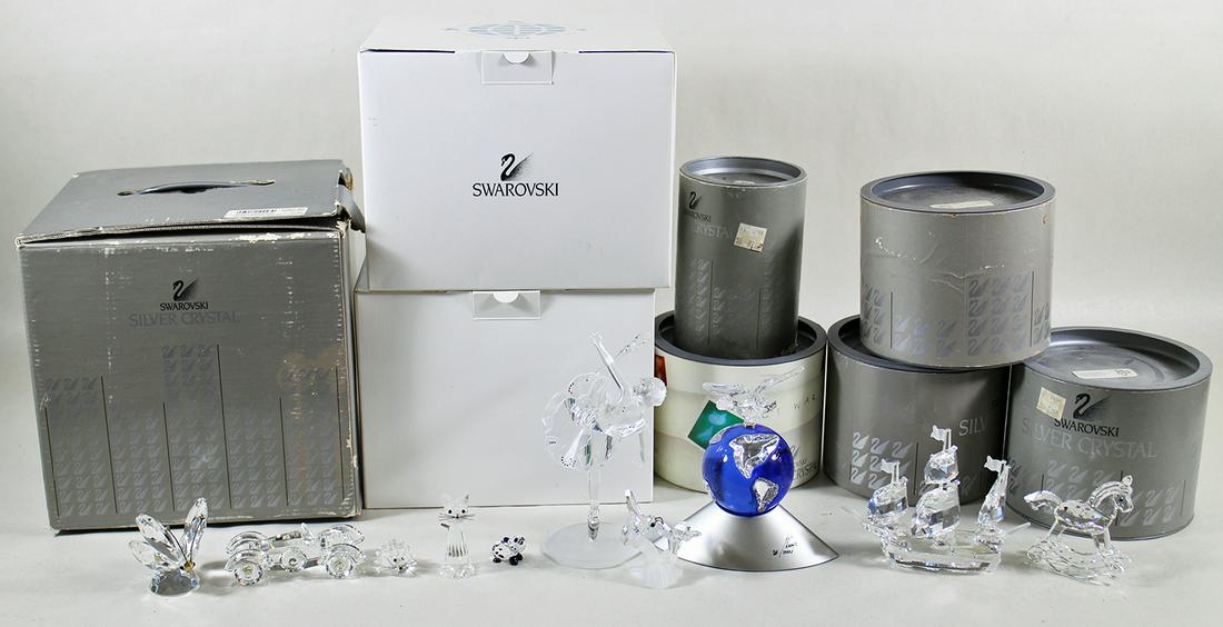 (8) SWAROVSKI CRYSTAL FIGURINES: Collection of (8) Swarovski Crystal figurines with boxes including car, butterfly, rocking horse, Santa Maria, ballerina, crystal planet, & more. Some of the box foam coming apart.