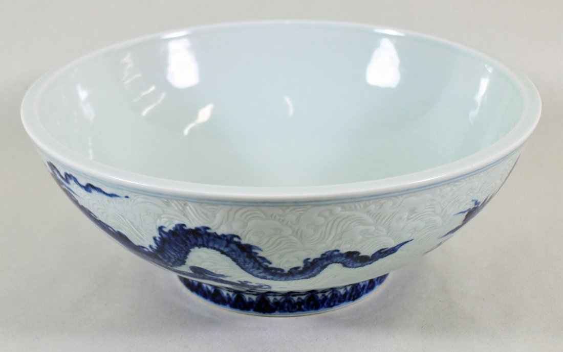 XUANDE CHINESE DRAGON BOWL: Anhua style decorated dragon bowl with blue six character Xuande mark. Measures 10.25" wide.