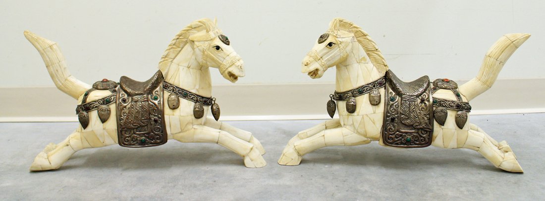 (2) BONE HORSE SCULPTURES: Pair of bone horse sculptures with metal jeweled saddles. Each measures 12.5" tall, 20.25" long.