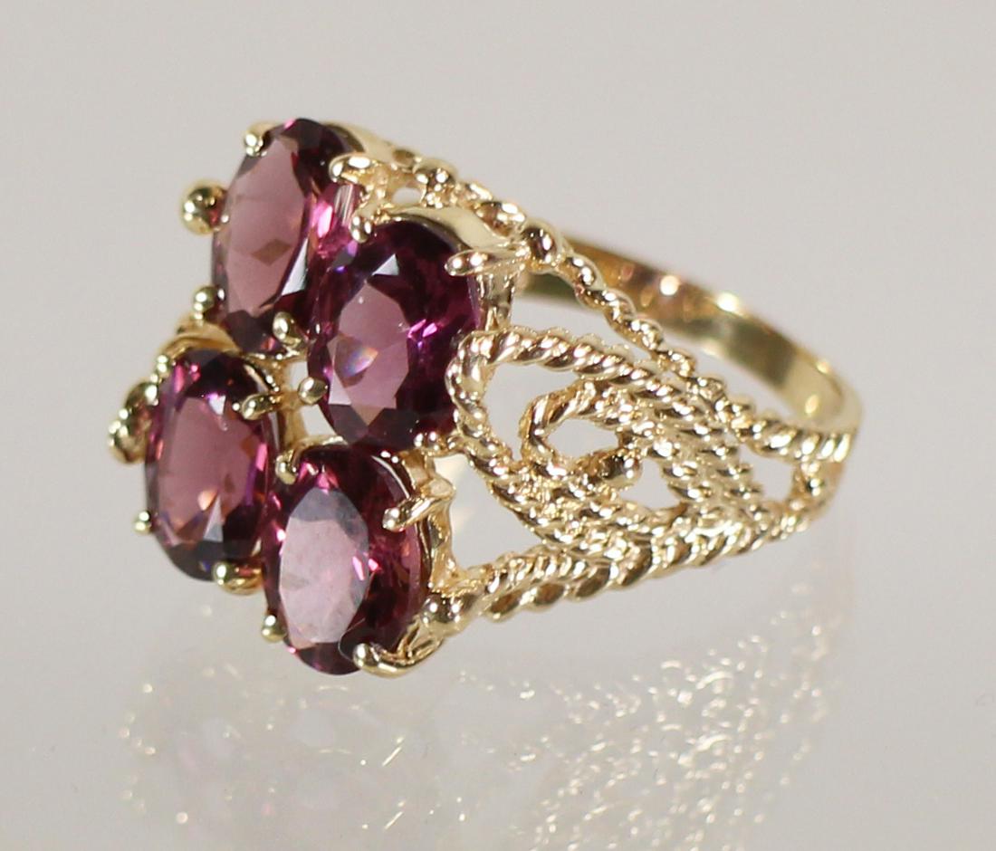 14K RHODALITE GARNET RING: 14KT Yellow gold rhodalite garnet ring with four oval garnets 3.00 TCW. Size 9, weighs 5.4 grams.