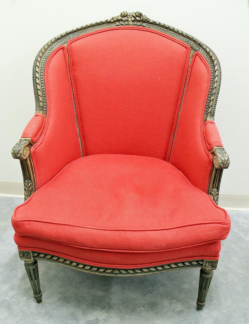 VINTAGE CARVED WING CHAIR: Carved with flower accents and red upholstery. Measures 29" wide 40.5" tall to back.