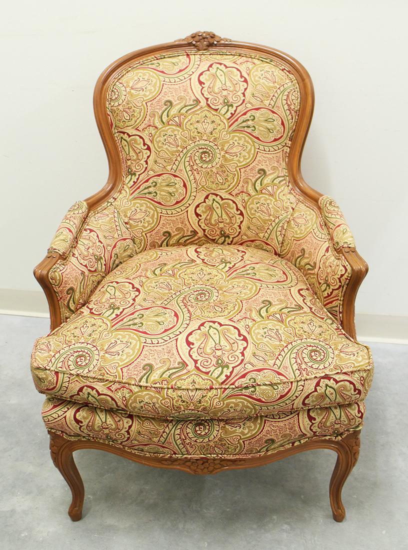 BERGERE FRENCH ARMCHAIR: Carved flower accented armchair. Measures 26.5" wide 37.5" tall to back.