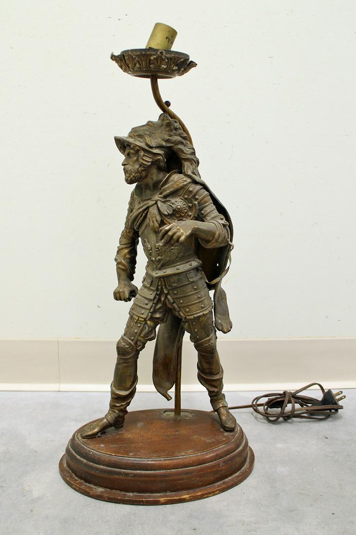 ANTIQUE CONQUISTADOR LAMP: Antique figural metal lamp of a conquistador. Measures 22.5" tall.