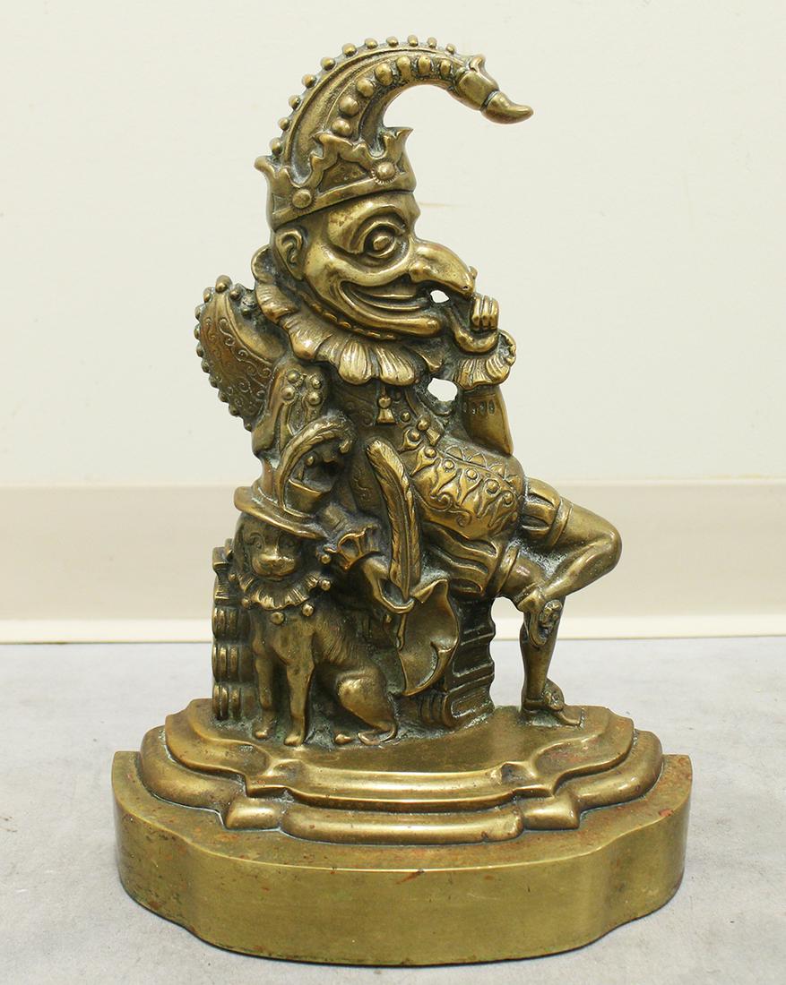 FIGURAL "PUNCH" DOOR STOP: Heavy figural doorstop of Punch seated with dog. Measures 13.75" tall.
