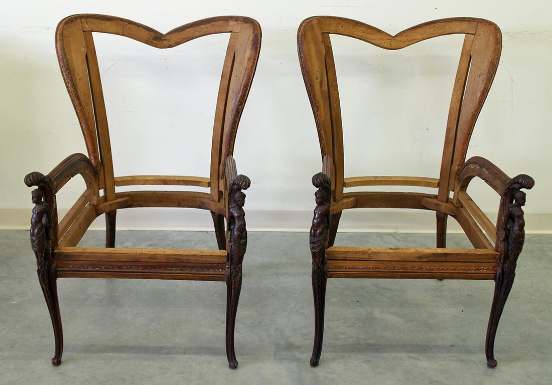 (2) ANTIQUE CARVED ARMCHAIRS: Pair of antique carved wood armchairs with nude female accents. Chairs are stripped and ready to be upholstered. Each measures 25 1/2" x 23 1/2" wide. Some age related wear.