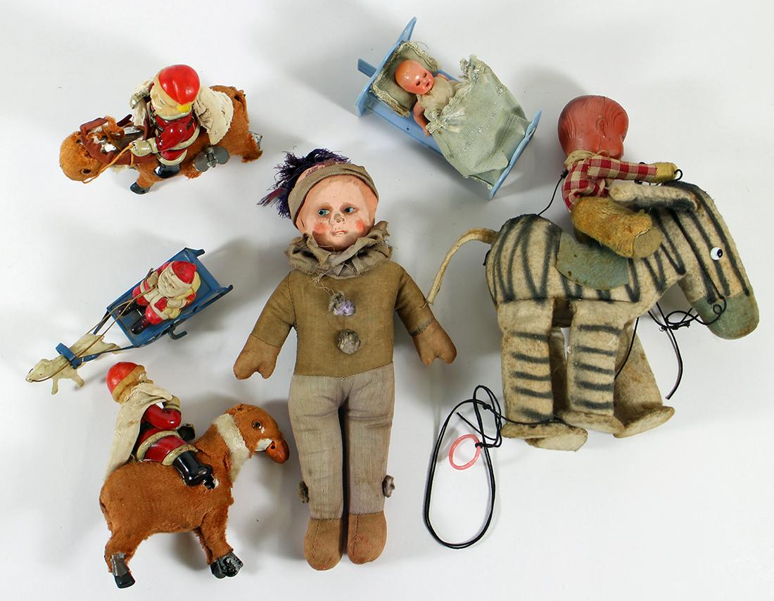 ANTIQUE WIND UP TOYS AND MORE: A collection of old toys including a cloth body doll, Santa on reindeer, baby that gets out of bed and more. Needs restoration.