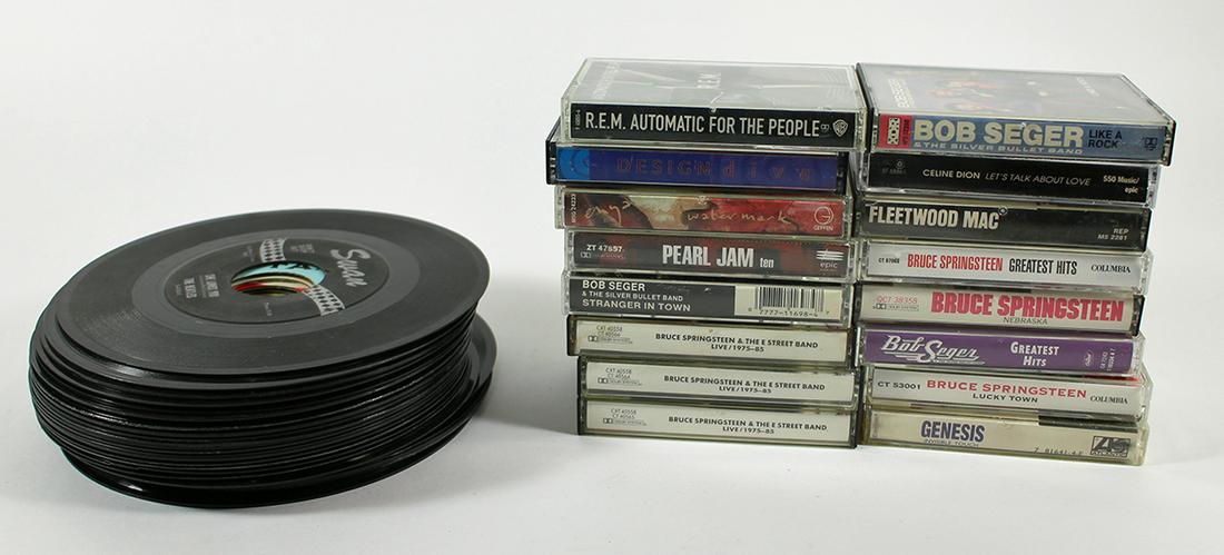VINTAGE 45 RPM RECORDS & CASSETTE TAPES: A collection of vintage rock and roll records and tapes.