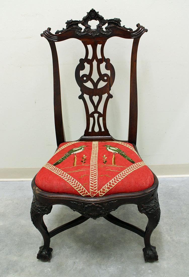 CHIPPENDALE NEEDLEPOINT CHAIR: Carved Chippendale wood chair with ball and claw feet. Needlepoint bird seat. Measures 22" x 18" wide 42" tall. Middle back wood piece loose.
