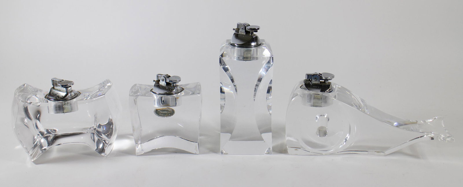 LUCITE LIGHTER COLLECTION: Collection of (4) vintage Modern lucite / acrylic lighters. Whale lighter 8.5" long (blemish/chip to side).