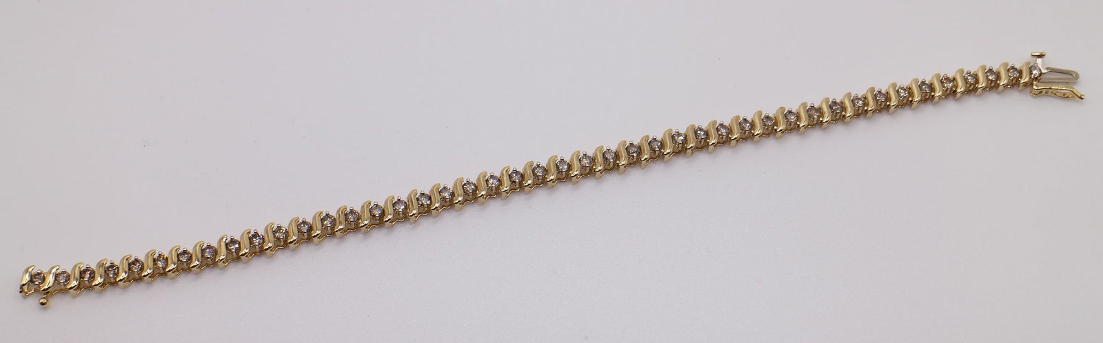 10K 2.20 TCW DIAMOND TENNIS BRACELET: 10KT Yellow gold tennis bracelet with (44) champagne color natural diamonds (2.20 TCW SI-I clarity). Measures 7" long, weighs 10 grams.