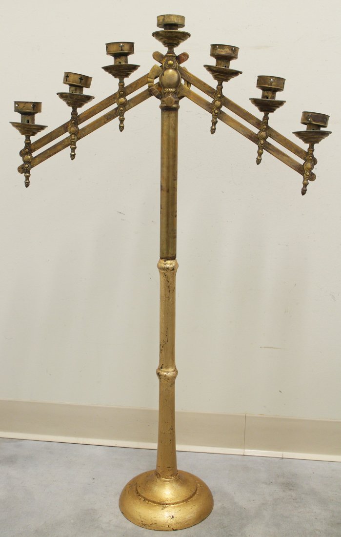 19TH CENTURY ADJUSTABLE CHUCH CANDELABRA: Floor or altar candelabra with seven adjustable up/down arms. Mounted on a gilt wood base. Open design crosses within circular wax catchers. Measures 38.5" tall 24" x 9" wide.