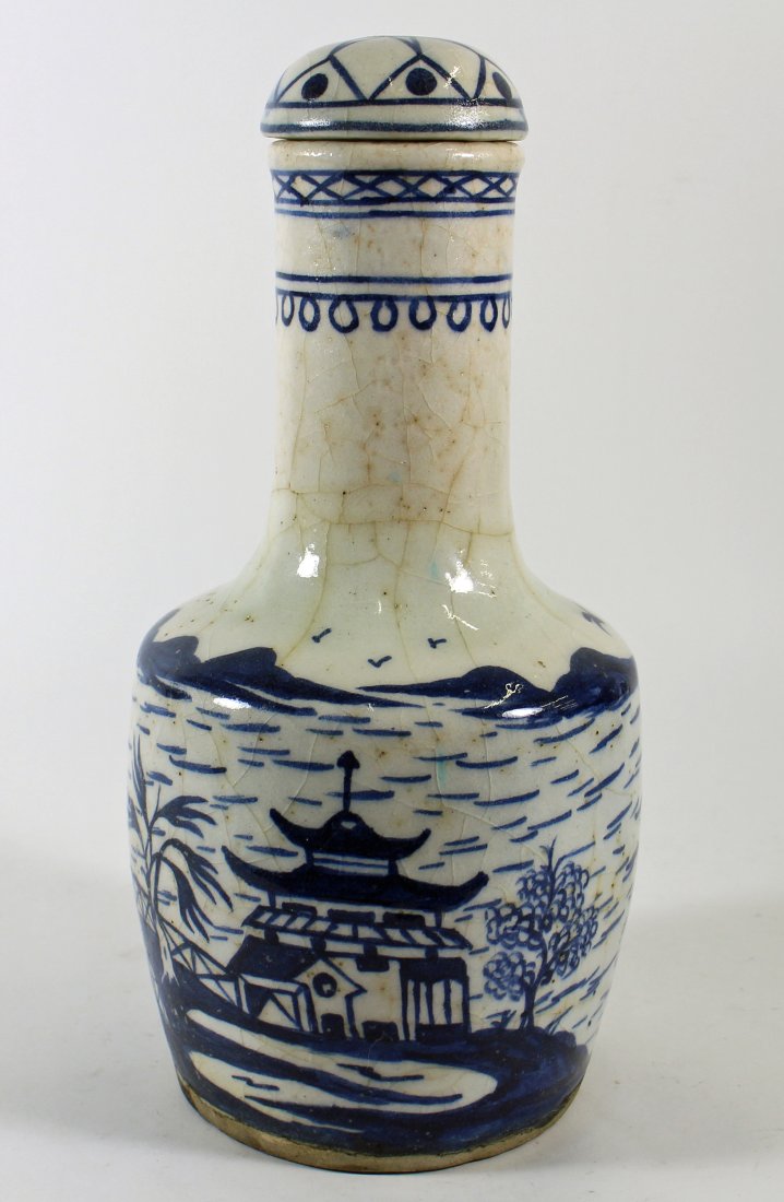 ANTIQUE CHINESE BLUE & WHITE POTTERY VESSEL: Large blue & white Chinese vase with pagoda, birds, trees, and fish with mountains in the background. Measures 12.5" tall.