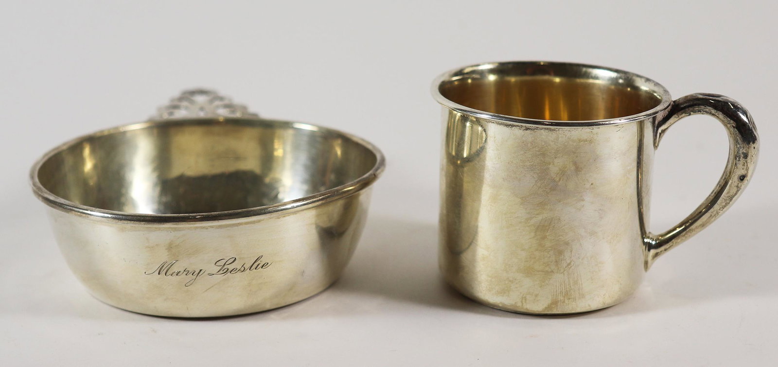 STERLING SILVER BABY CUP & PORRINGER: Sterling silver baby cup mug and 4.25" wide without handle porringer. Some indentations. Weighs 4.7 OZT (147 grams).