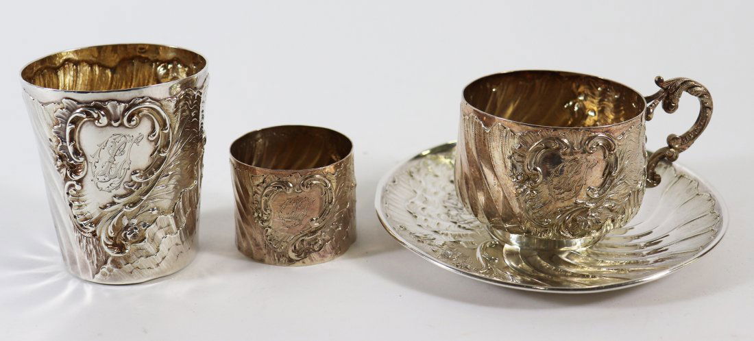 FRENCH AESTHETIC SILVER COLLECTION V. BOIVIN: Collection of Frensh silver including teacup & saucer, cup, and napkin ring. Fluid wave shell design with repousse scroll. Cup 3" tall, total weight 11 OZT. French silver hallmark and VB Victor Boivin
