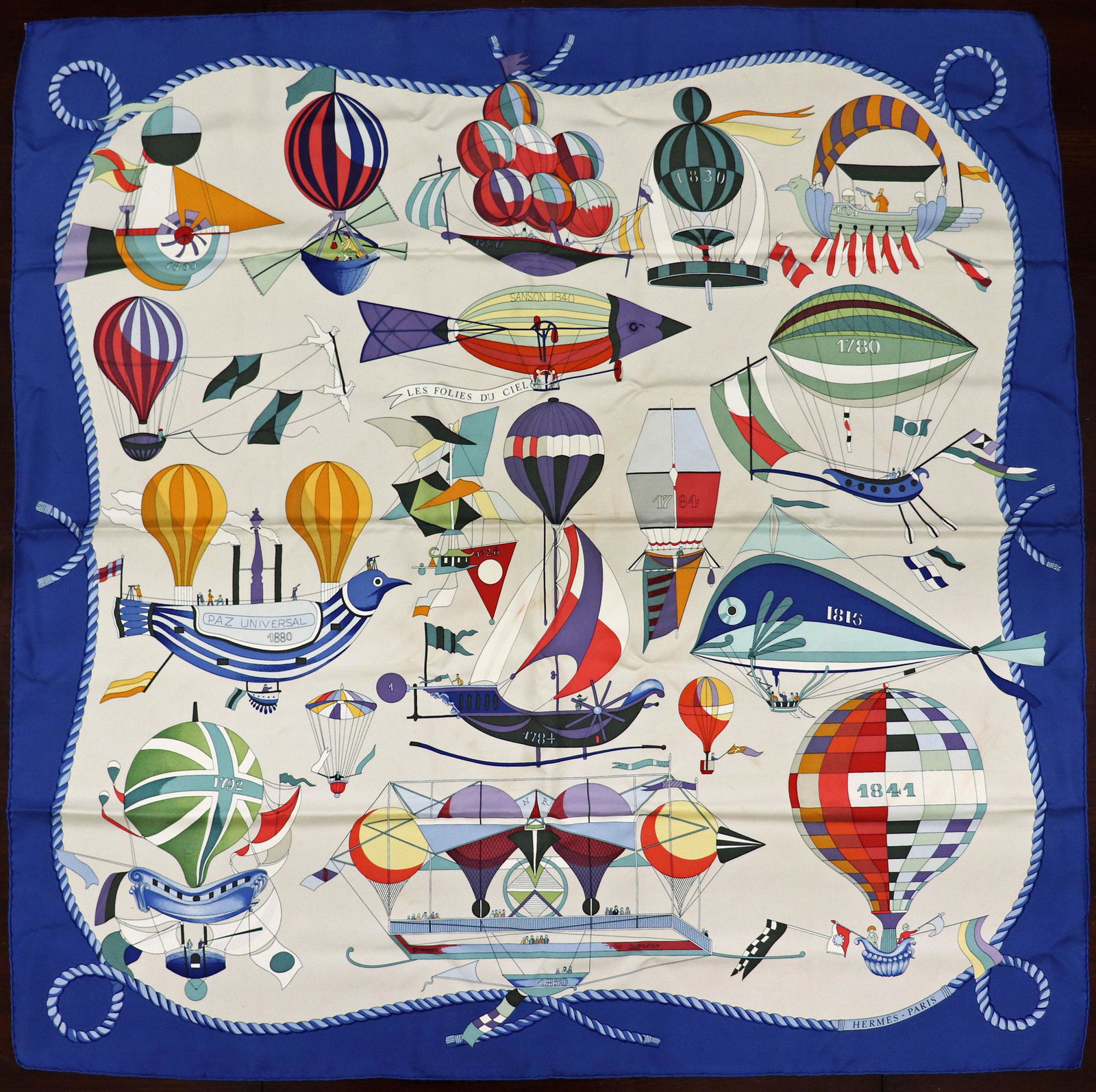 HERMES LES LOLIES DU CIEL SILK SCARF - DUBIGEON: A vintage Hermes silk scarf designed by Loic Dubigeon. It measures 35" and has the original box. Some staining.