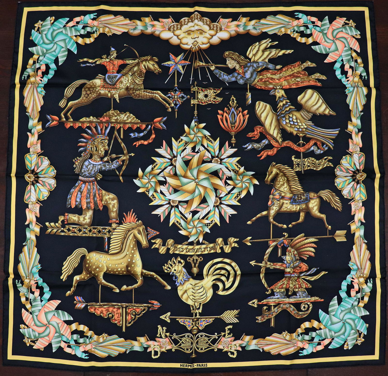 HERMES LES GIROUETTES SILK SCARF - JOACHIM METZ: A Hermes silk scarf designed by Joachim Metz. It is approx 35" and comes with the original box. It does not look like it was ever worn. This was a gift given by Larry King to his wife Julia and includ