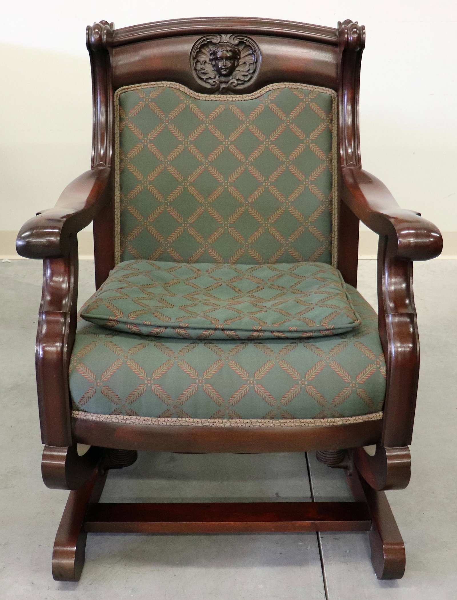 19TH CENTURY CARVED CHERUB ROCKING CHAIR: 19th Century wood rocking chair with carved cherub portrait. Measures 27" x 28" wide.