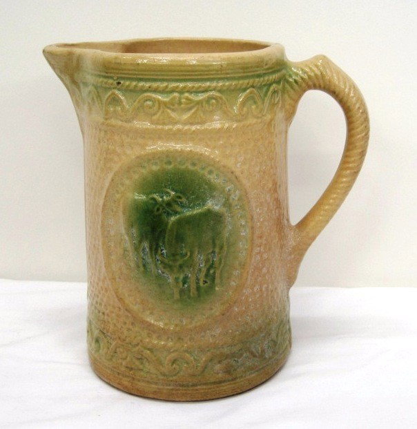 Antique Hull Yellow Ware Cream Pitcher: Raised Cow Design. 7" Tall.