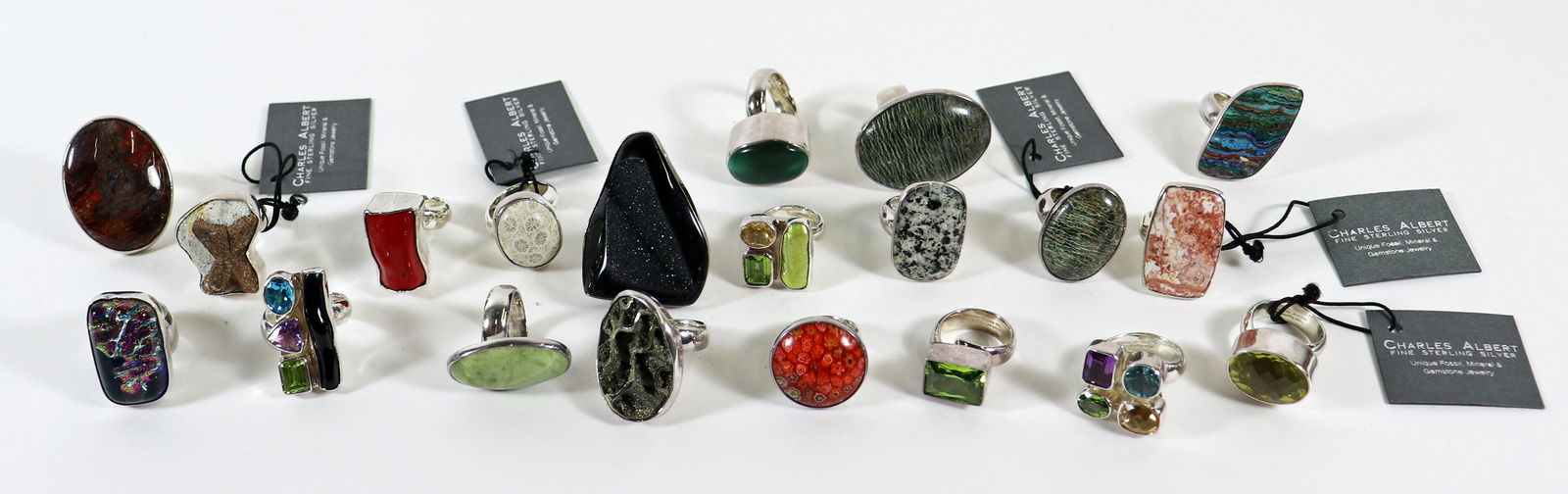 (20) CHARLES ALBERT STERLING SILVER GEMSTONE RINGS: An assortment of 20 sterling silver rings by Charles Albert. They are sizes 6 - 8. Charles Albert jewelry is made of natural stones and can include Kyanite, Ammonite, Shark tooth, Geode, Pearl, Agate,