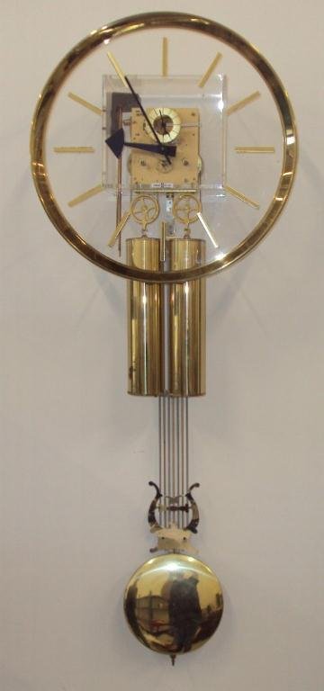 HOWARD MILLER WALL CLOCK: SERIAL NUMBER 9842190540. MADE IN GERMANY. 40 1/2" LONG, 15" WIDE.