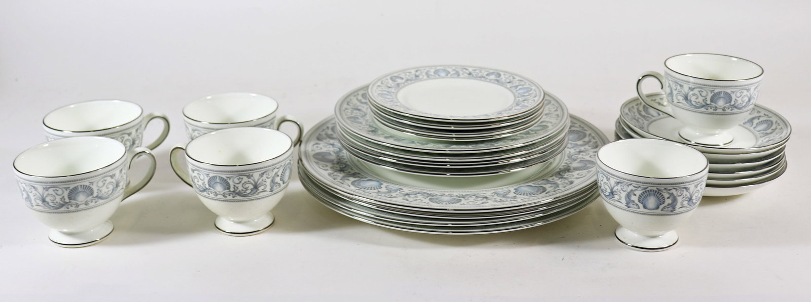 24 PIECE WEDGWOOD DOLPHINS CHINA SET: Set of Wedgwood bone china with a light blue dolphin and seashell motif. Includes 4 dinner plates, 4 salad plates, 4 dessert plates, 6 cups and 6 saucers.