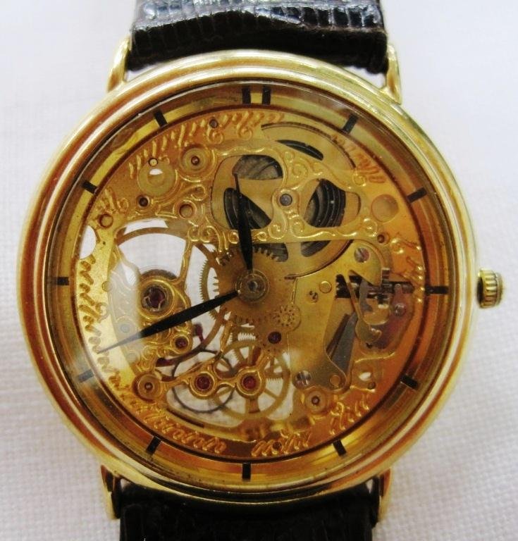 14K MEN'S SKELETON MECHANICAL WATCH: Great looking 14K gold skeleton watch - you can see the movements working and moving. Watch is wind up and in working condition. Band is genuine lizard.