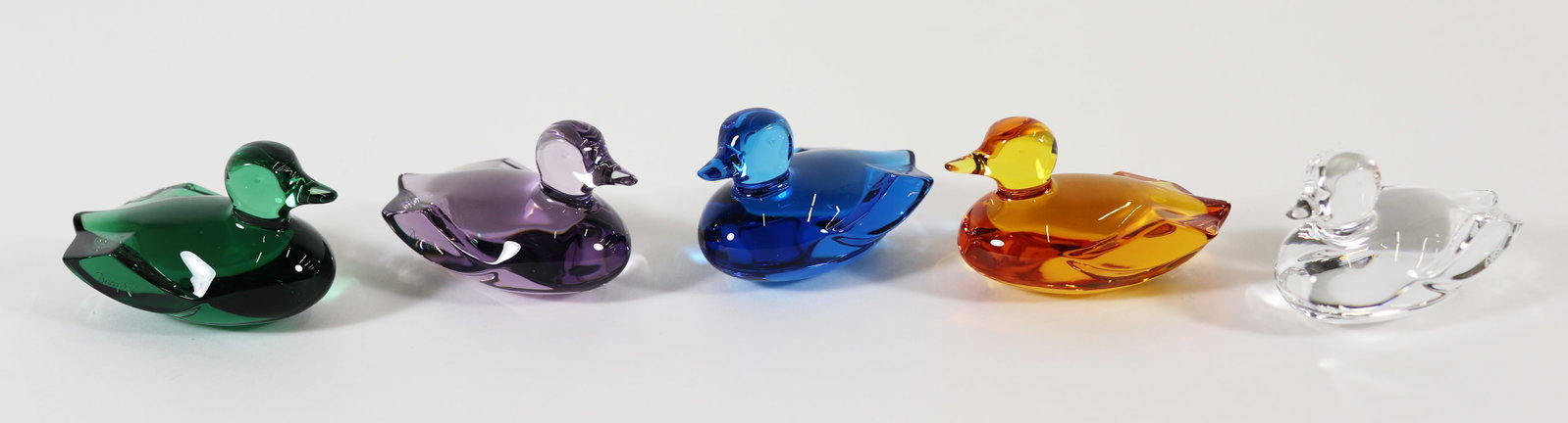 (5) BACCARAT CRYSTAL DUCK FIGURINES: Collection of (5) Baccarat Crystal ducks in clear, purple, green (chip to back), blue, and orange. 2.5" long.