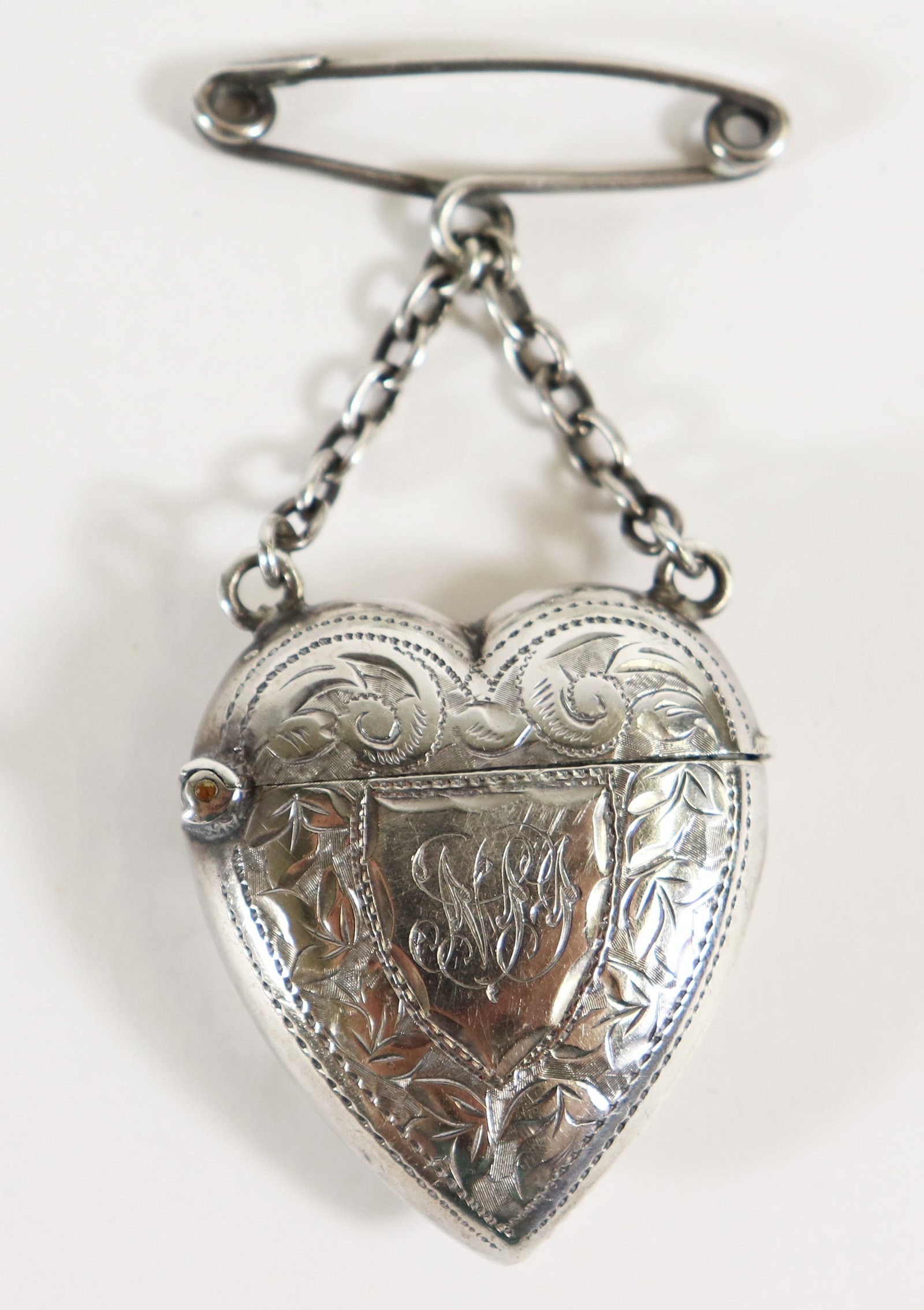 ENGLISH STERLING SILVER HEART MATCH VESTA: English sterling silver hallmarked heart match vesta with striker. Heart approximately 1.5" long.