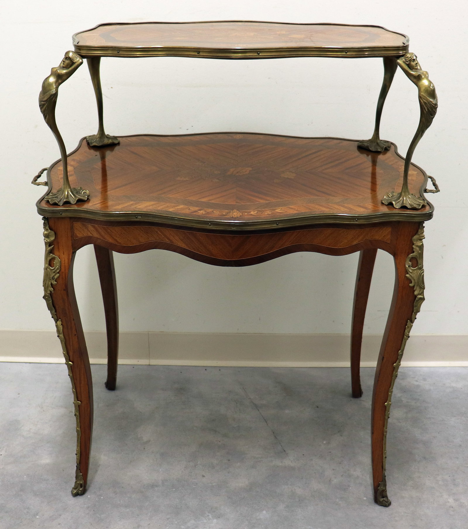 LOUIS XV STYLE MARGUETRY BRONZE TWO TIER TEA TABLE: Antique two tiered inlaid wood Louis XVI style dessert table with bronze semi nude caryatid mounted to support the top. Inlaid floral design on each tier with cabriole legs. Measures 38" tall 32" x 20