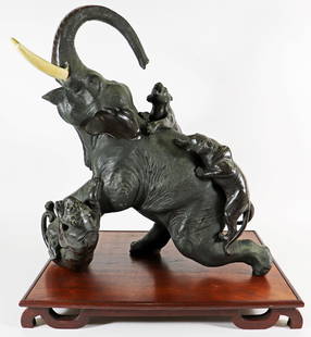 JAPANESE MEIJI BRONZE TIGERS ATTACKING ELEPHANT: Japanese Meiji period large bronze sculpture of an elephant with three tigers attacking. Signed on bottom. Measures 18.5" long 20.5" tall. Includes wood display stand.