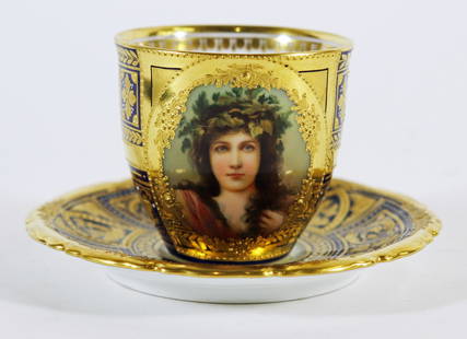 ROYAL VIENNA PORCELAIN DEMITASSE CUP & SAUCER: Royal Vienna hand painted gold and cobalt blue demitasse / teacup & saucer. Cup has a portrait of young woman with leaf headdress crown. Teacup 2.25" tall saucer 4.25" wide.