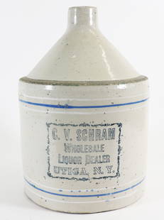 C.V.SCHRAM WHOLESALE WHISKEY DEALER UTICA NY JUG: Large handled stoneware whiskey advertising crock. The front reads C.V. Schram Wholesale Whiskey Dealer Utica NY. Measures 13" x 9".