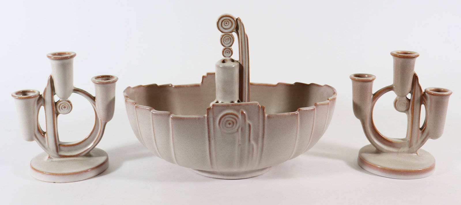ROSEVILLE POTTERY MODERNE LINE COLLECTION: A collection of Roseville pottery in the "moderne" pattern to include a console bowl 11" x 7" x 4" with a flower frog that resembles a water well and a pair of triple port candle holders. A few small 