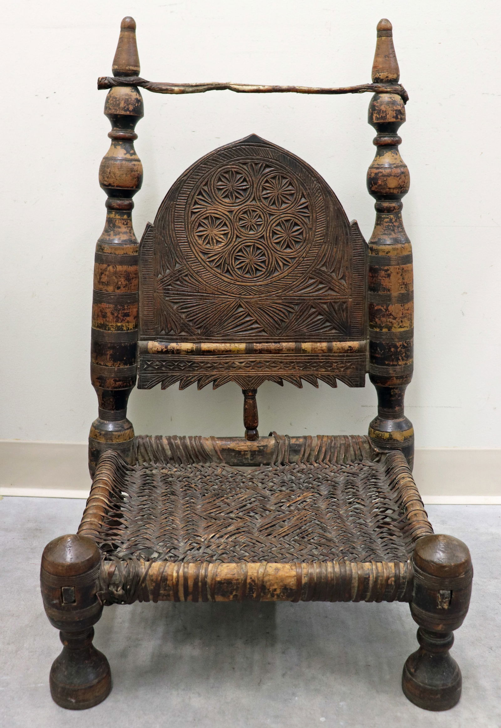 ANTIQUE SWAT VALLEY TRIBAL CHAIR: Antique low Pakistan tribal chair with age related wear. Measures 31" tall x 18" wide x 16" deep, chair height 7'