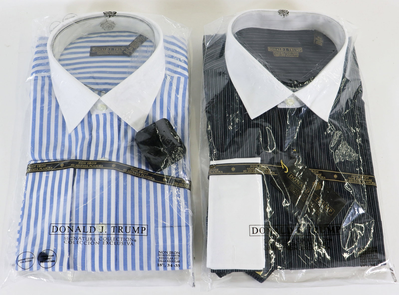 (2) DONALD TRUMP DRESS SHIRT SETS - BRAND NEW: Pair of Donald J Trump dress shirts new in original bags. A blue and white pinstripe shirt with a pair of Commander in Chief cufflinks and a a black and white dress shirt with a matching tie. Both wer