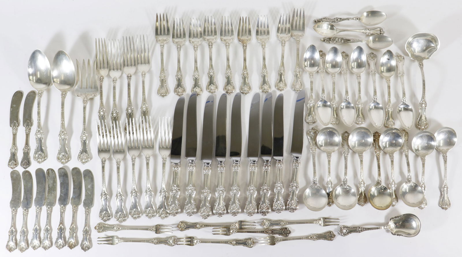 FRANK SMITH STERLING FLATWARE SET: Frank Smith sterling silver flatware set including (9) knives, (9) forks, (9) butter spreaders, (8) teaspoons, (9) soup spoons, (9) salad/dessert forks (two larger), (7) seafood/cocktail forks, (2) se