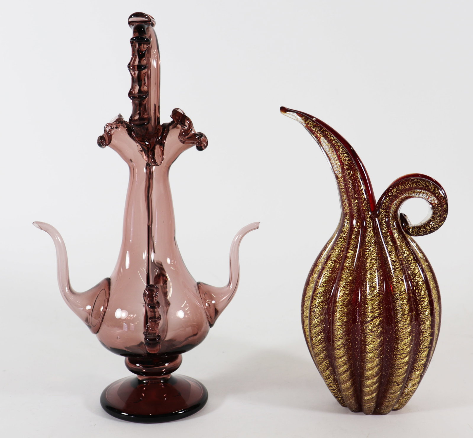 (2) MURANO ART GLASS EWER PITCHERS: A blown glass double spout vase and a gold fleck with red glass pitcher. 9" to 12" tall.