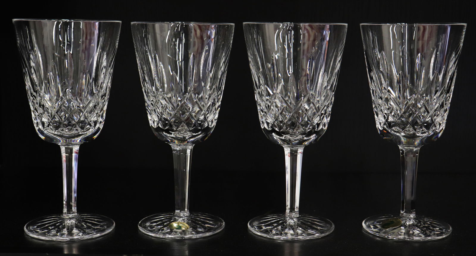 (4) WATERFORD CRYSTAL LISMORE WATER GOBLETS: Set of (4) Waterford Crystal Lismore pattern water / wine goblet glasses. Approximately 6 7/8" tall.