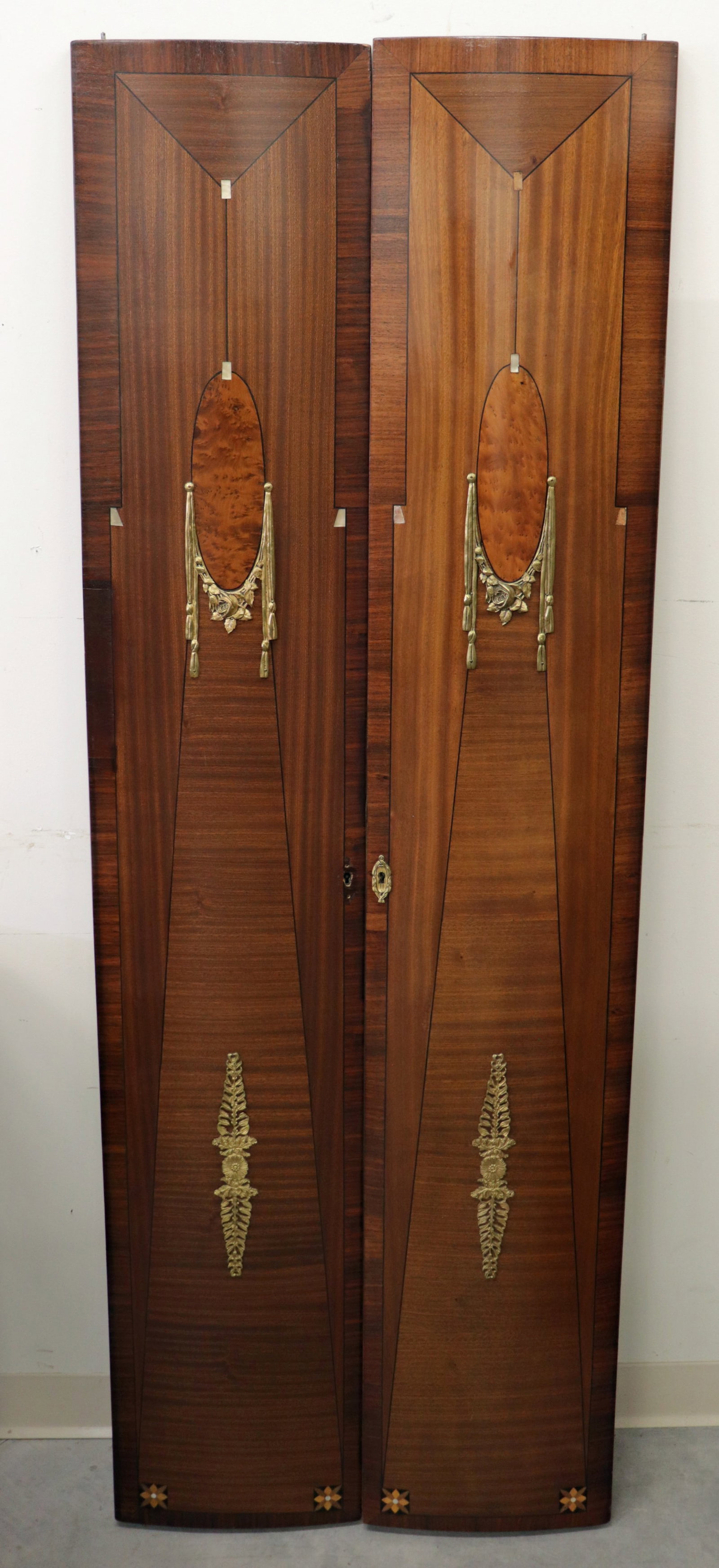 ART DECO INLAID WOOD DOOR PANELS: Pair of Art Deco design inlaid wood door panels with ormolu mounts. Each panel measures 72.25" Tall 13" wide.